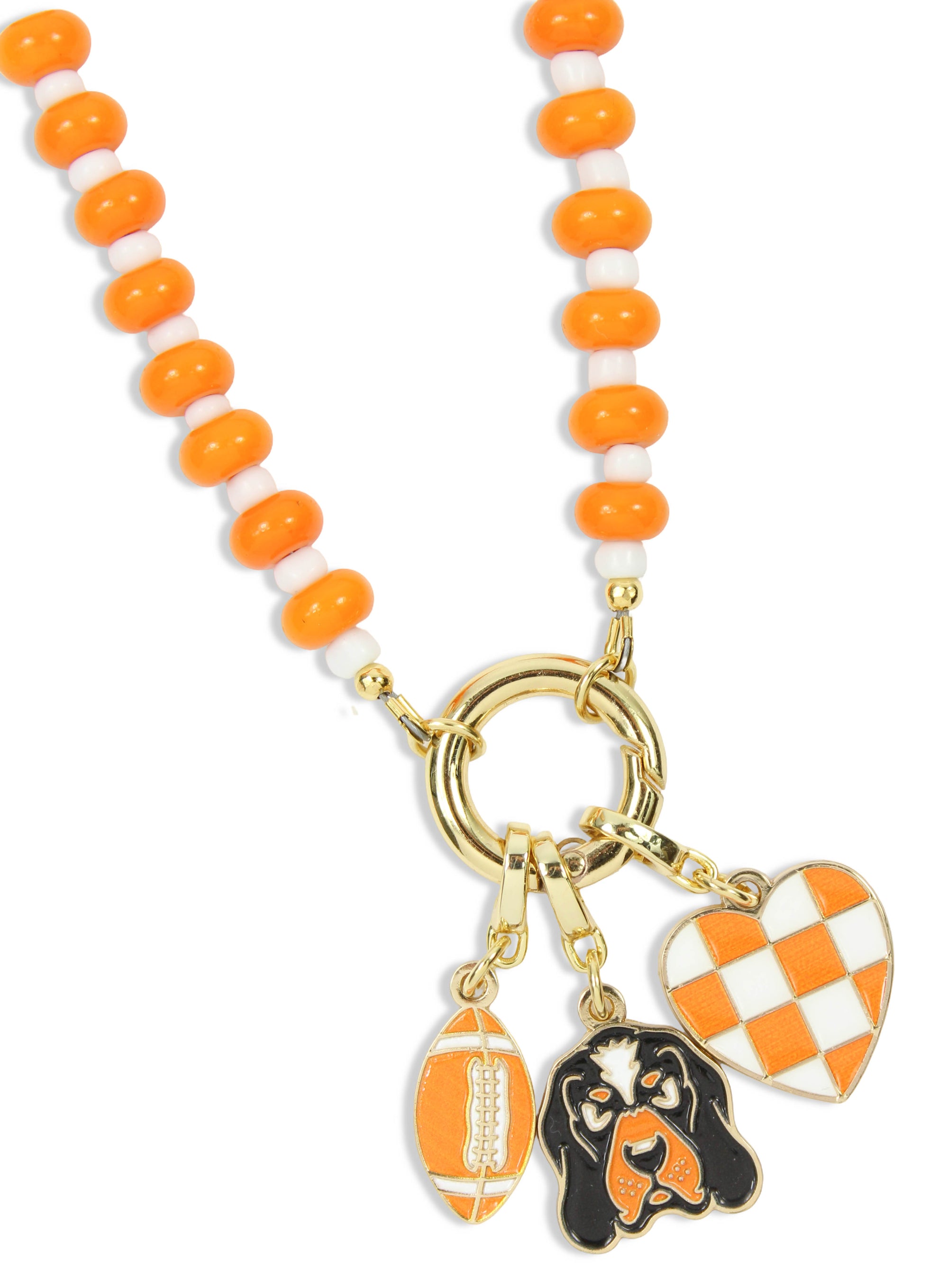 An orange and white beaded necklace with gold-tone hardware, featuring three dangling charms: a football, a black-and-orange dog portrait, and an orange-and-white checkered heart.