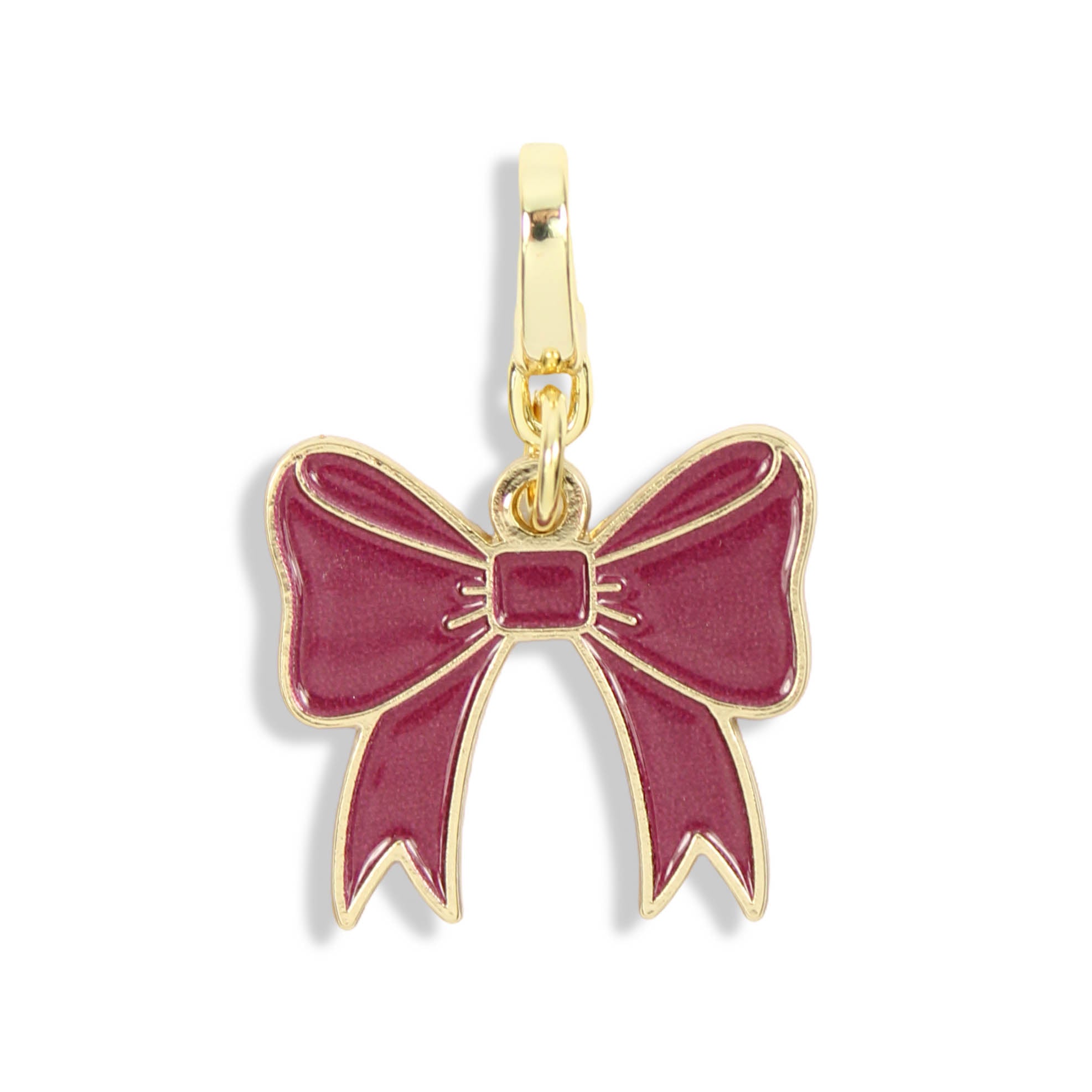 Garnet enamel bow clasp charm with gold-tone detailing on a white background.