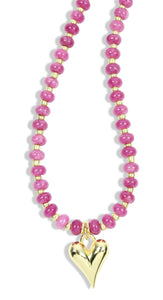 Pink beaded necklace with gold accents and gold heart pendant