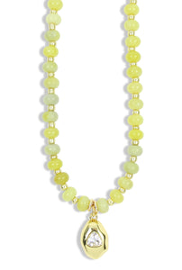 Chartreuse beaded necklace with gold accents and crystal pendant
