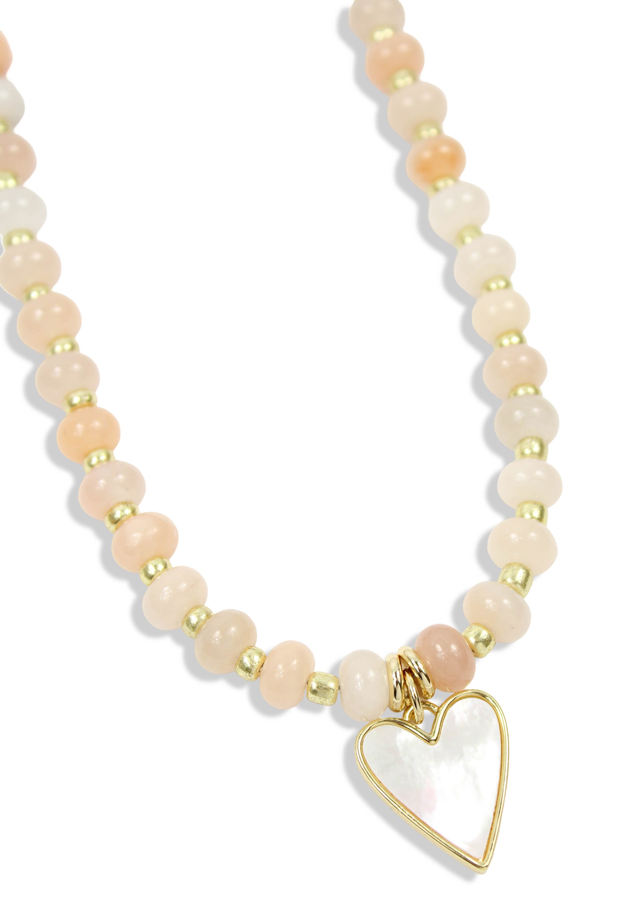 Peach beaded necklace with gold accents and mother of pearl heart pendant