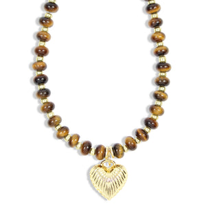 A beaded necklace featuring polished brown and black tiger's eye beads separated by small gold spacer beads, with a textured gold heart-shaped pendant at the center, shown against a plain white background.