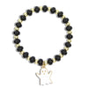 A beaded stretch bracelet featuring glossy black round beads alternating with shiny gold metallic beads, with a white ghost-shaped charm outlined in gold at the bottom, shown on a plain white background.