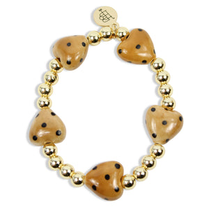 Annie Honey Heart Stretch Bracelet with honey-colored heart-shaped beads, black speckled details, polished gold spacer beads, and signature gold tag by Bourbon and Boweties