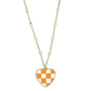 Dainty gold chain necklace featuring an orange and white checkered heart pendant by Bourbon and Boweties.